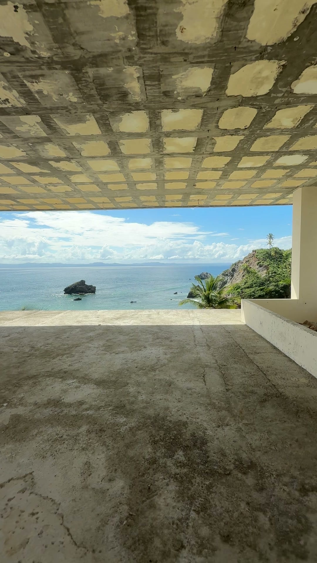 A coffered ceiling over an open terrace facing the sea