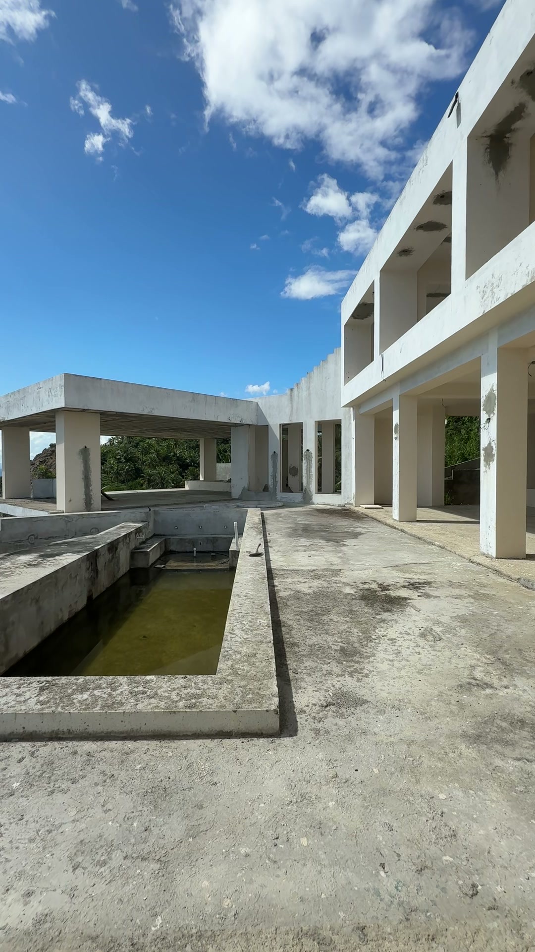 A long courtyard with a channel of water and the upper floors beside it